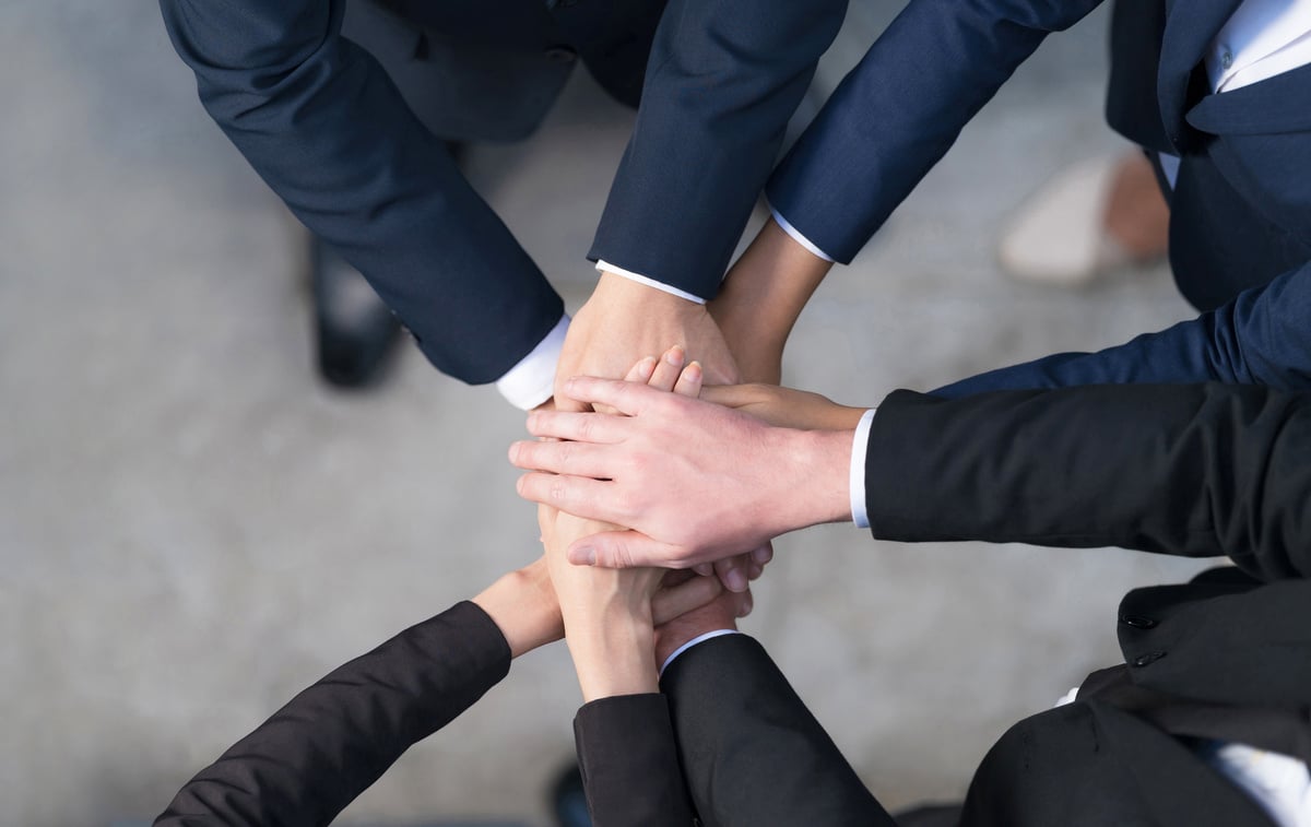 Top View, Cropped View of a Group of Business People Putting the